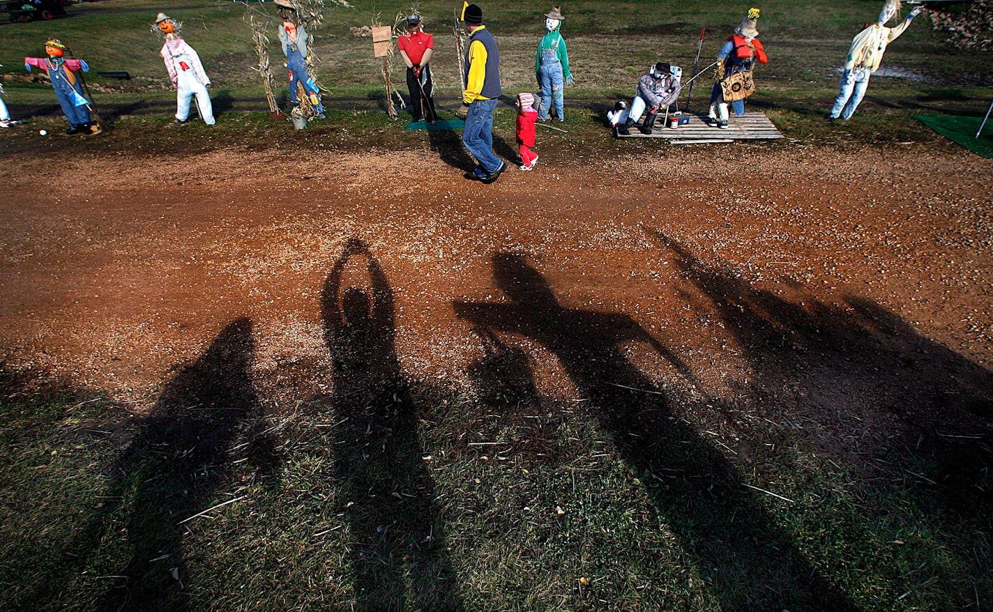 JIM GEHRZ ¥ jgehrz@startribune.comBelle Plaine/October 31, 2009/10:30 AMAaron Sanders and his daughter, Erica, 3, Shakopee, explored the unusual sights at the 26th Orchard and Farm in Belle Plaine.Annual Scarecrow Festival at Emma Krumbees