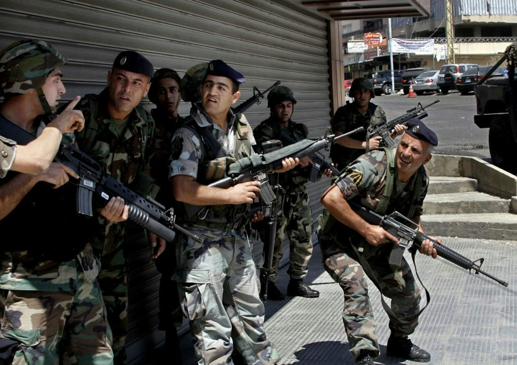 Lebanese army soldiers, take their positions during clashes between followers of a radical Sunni cleric Sheik Ahmad al-Assir and Shiite gunmen, in the southern port city of Sidon, Lebanon, Sunday, June 23, 2013.