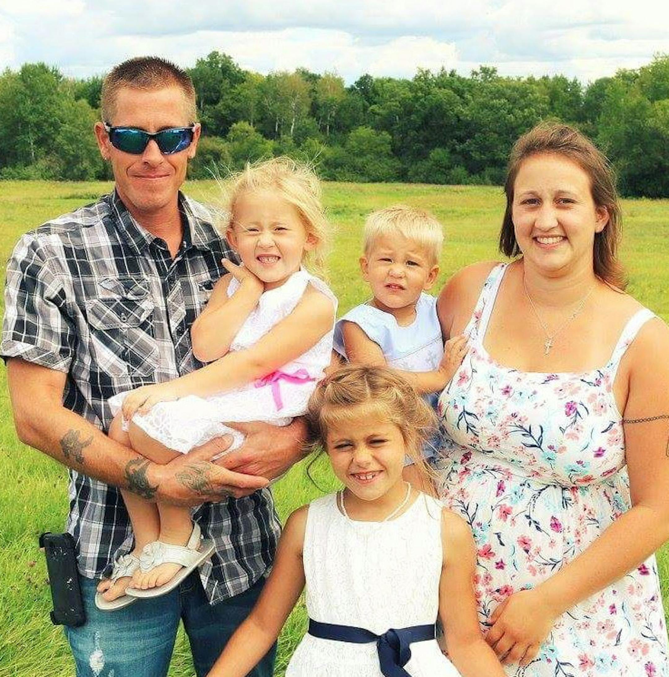 Eric Fryman, left, Annaliese, 5 (in Eric's arms) Jansen,3, held by Cari Mews-Fryman, Kyra 9, in front. Eric and the three children died following a kayaking accident off Lake Superior's Apostle Islands. Cari Mews-Fryman survived.