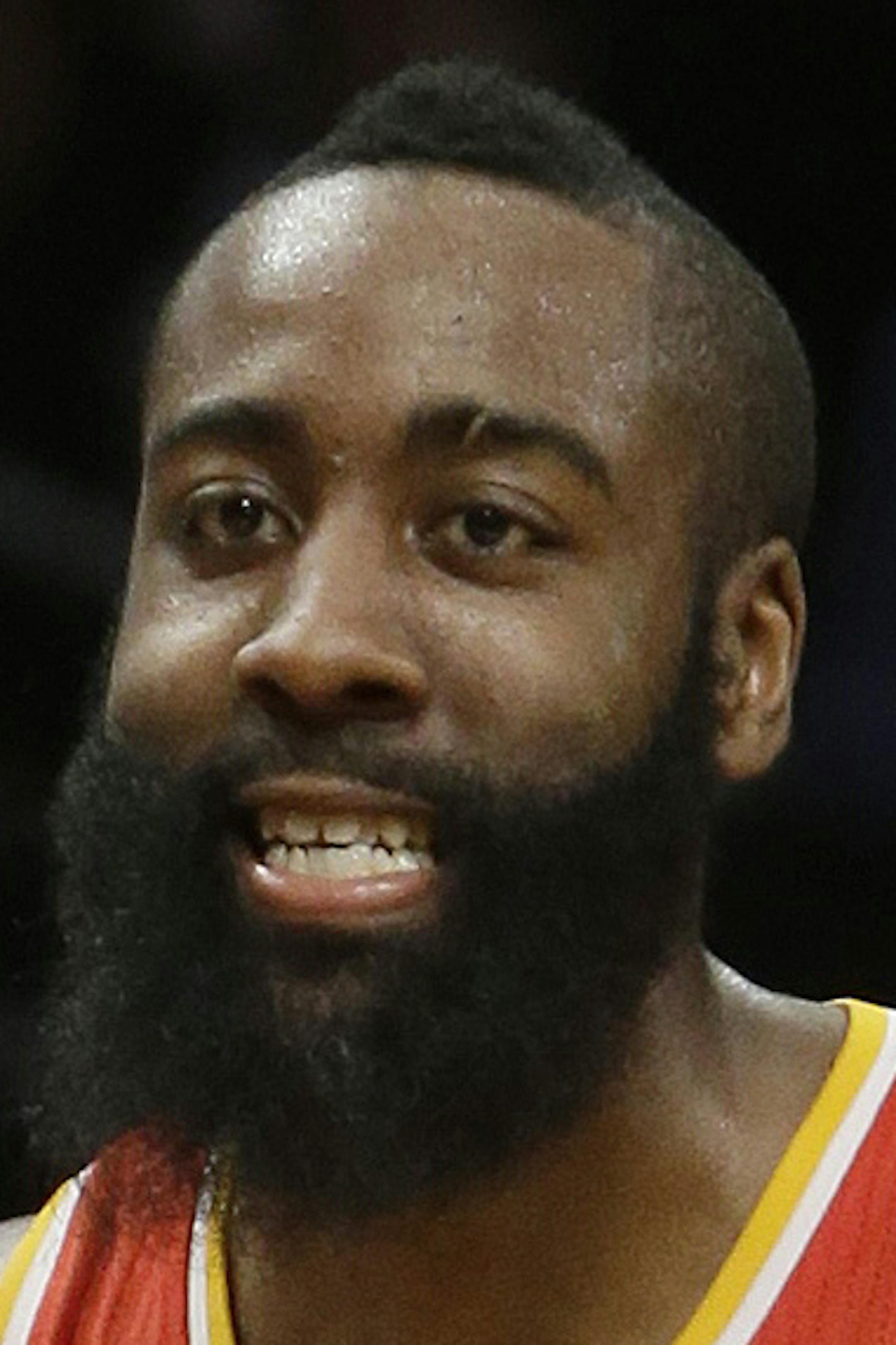 Houston Rockets' James Harden (13) talks to fans as Brooklyn Nets' Deron Williams (8) looks on during the second half of an NBA basketball game, Friday, Feb. 22, 2013, in New York. The Rockets won the game 106-96. (AP Photo/Frank Franklin II) ORG XMIT: MIN2013031418354231
