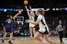 Iowa guard Caitlin Clark (22) puts up a three-point shot against LSU during the third quarter of an Elite Eight round college basketball game during t