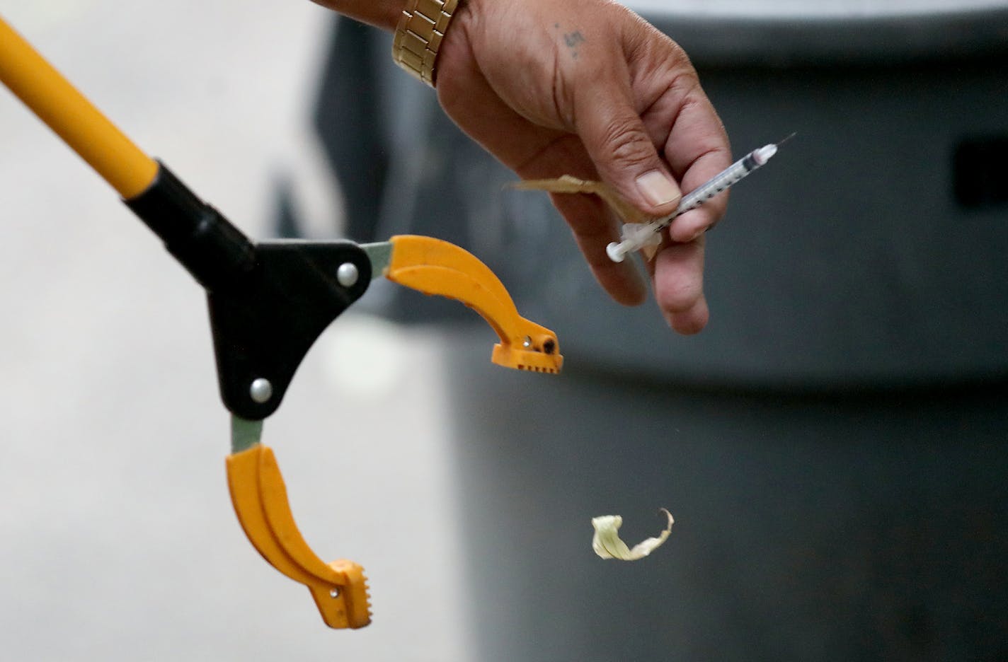 Salvador Pacheco, director of facility and security services at Minnesota Indian Women's Resource Center, prepares to discard a used syringe during his morning rounds Thursday, June 20, 2019, in Minneapolis, MN. Discarded needles and other signs of drug use are personal to Pacheco who lives in an apartment at MIWCR near one of his daughters and two grand children and has family members fighting substance abuse. "They're people," he said. "They're somebody's son, mom, somebody's daughter." Pachec