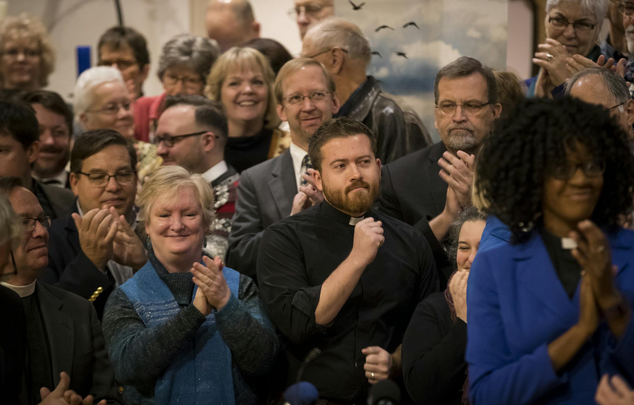 Pastor Eric Hoffer, of Prince of Peace Lutheran Church in St. Louis Park, raised his fist in solidarity after local pastors express their support in being sanctuary and supporting churches for people who are at risk of deportation, Photographed at Lutheran Church of the Redeemer on Tuesday, December 6, 2016, in St. Paul, Minn. ] RENEE JONES SCHNEIDER &#x2022; renee.jones@startribune.com