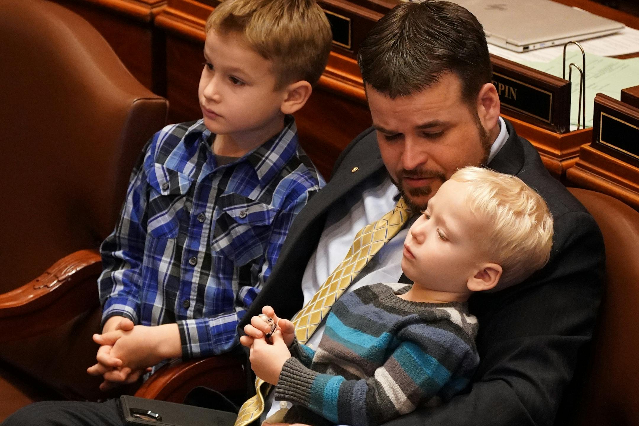 Rep. Josh Heintzeman, R-Nisswa, sat with his sons during the first day of the legislative session Tuesday.