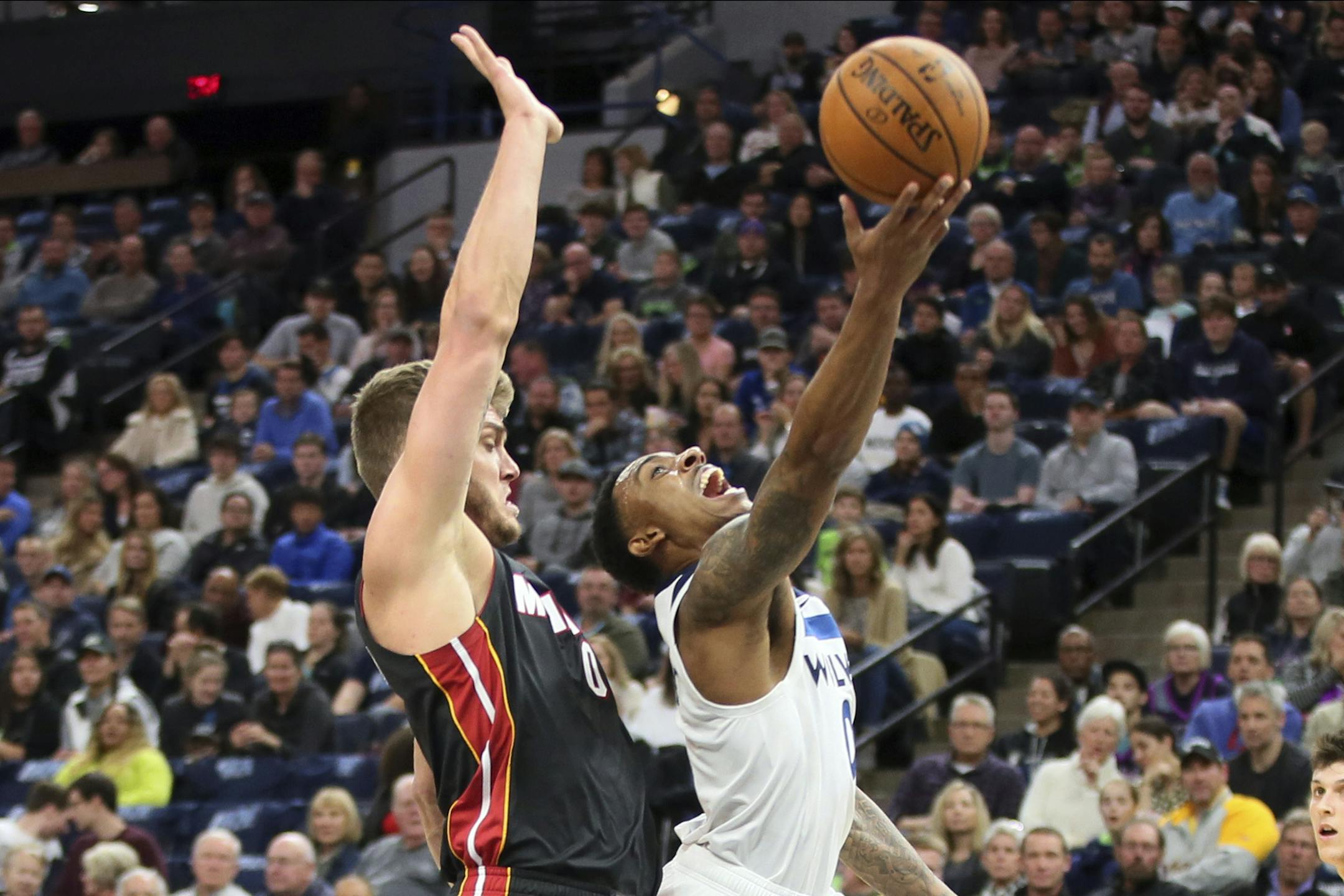 Minnesota Timberwolves' Jeff Teague, right, lays up a shot in front of Miami Heat's Meyers Leonard in the first half of an NBA basketball game Sunday, Oct. 27, 2019, in Minneapolis. (AP Photo/Jim Mone)