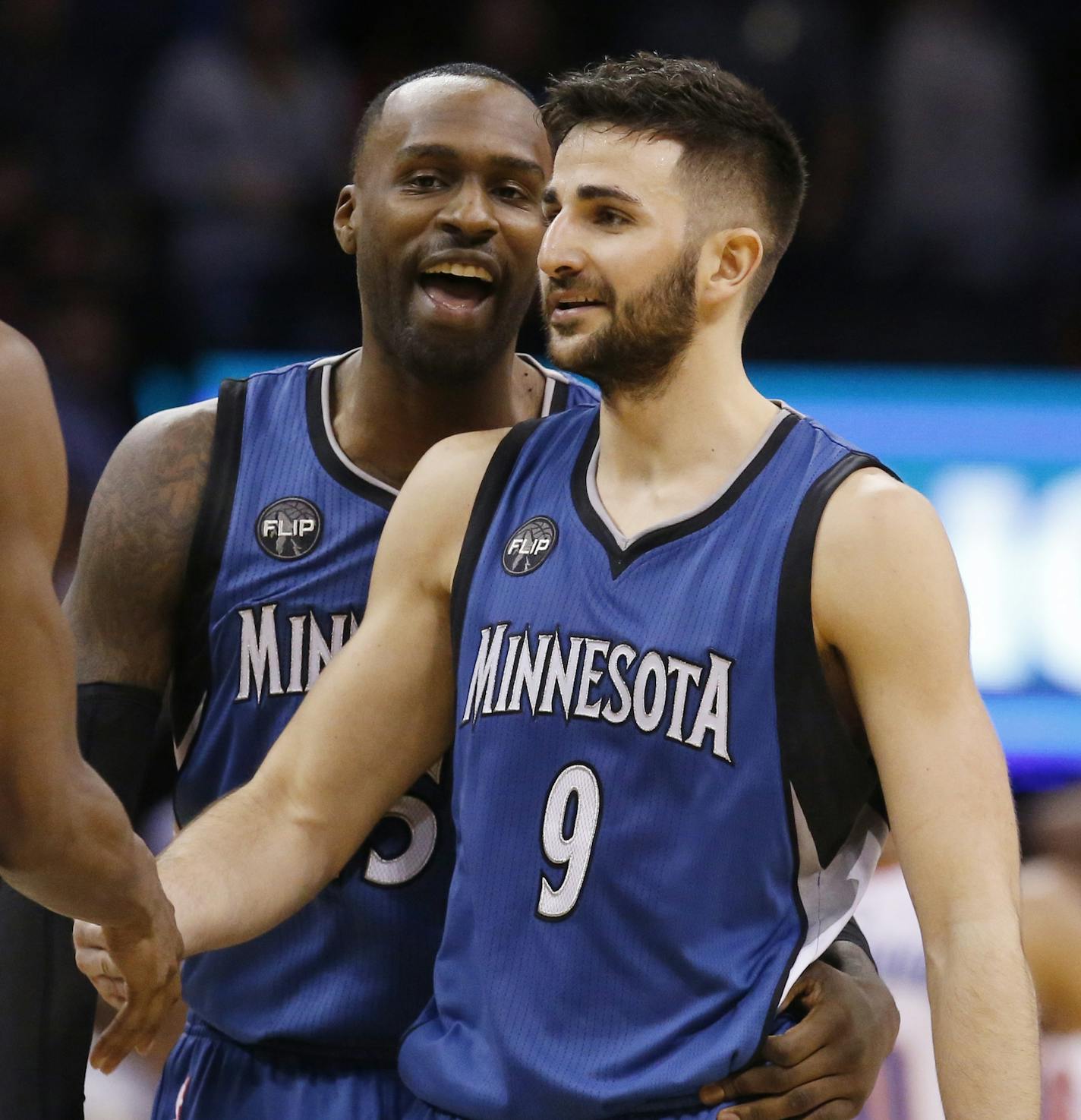 Minnesota Timberwolves guard Ricky Rubio, right, celebrates with teammate guard Andrew Wiggins, left, and forward Shabazz Muhammad, center, following an NBA basketball game against the Oklahoma City Thunder in Oklahoma City, Friday, March 11, 2016. Minnesota won 99-96. (AP Photo/Sue Ogrocki) ORG XMIT: OKSO