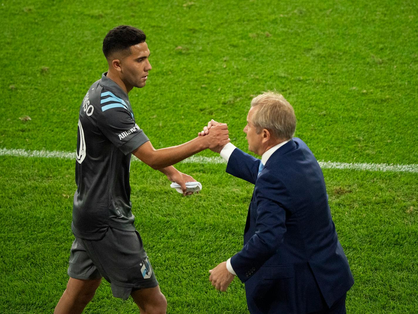 Loons midfielder Emanuel Reynoso was greeted by head coach Adrian Heath during a game on Sept. 6.