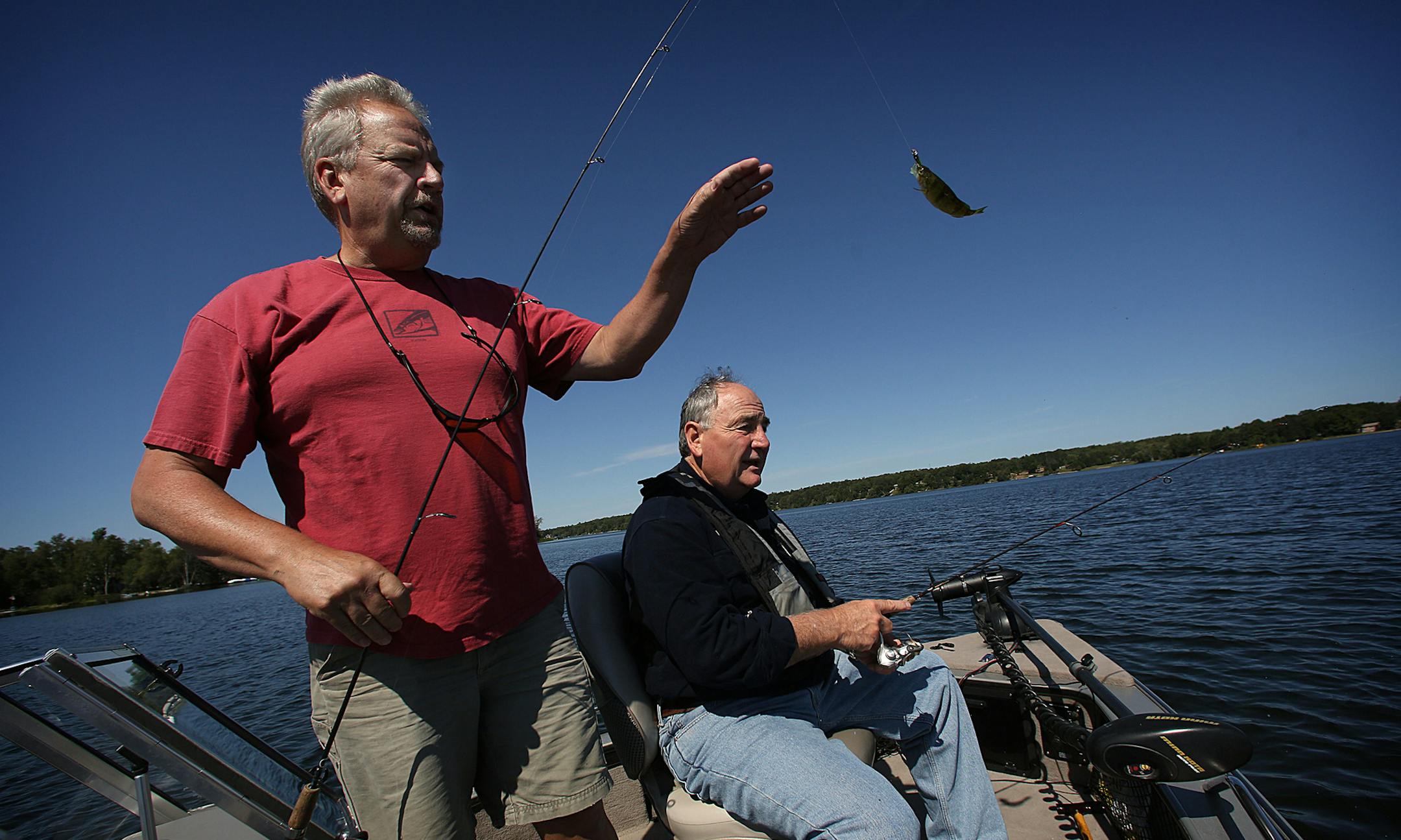 Brian Titus (shorts and red top) and his best friend, Tom Peltier, have gone fishing together year-round for 40 years. The pair continue to fish, despite Tom having suffered a stroke a few years ago. ] (JIM GEHRZ/STAR TRIBUNE) / September 3, 2013, Grand Rapids, MN ‚Äì BACKGROUND INFORMATION- FOR DUETS COLUMN