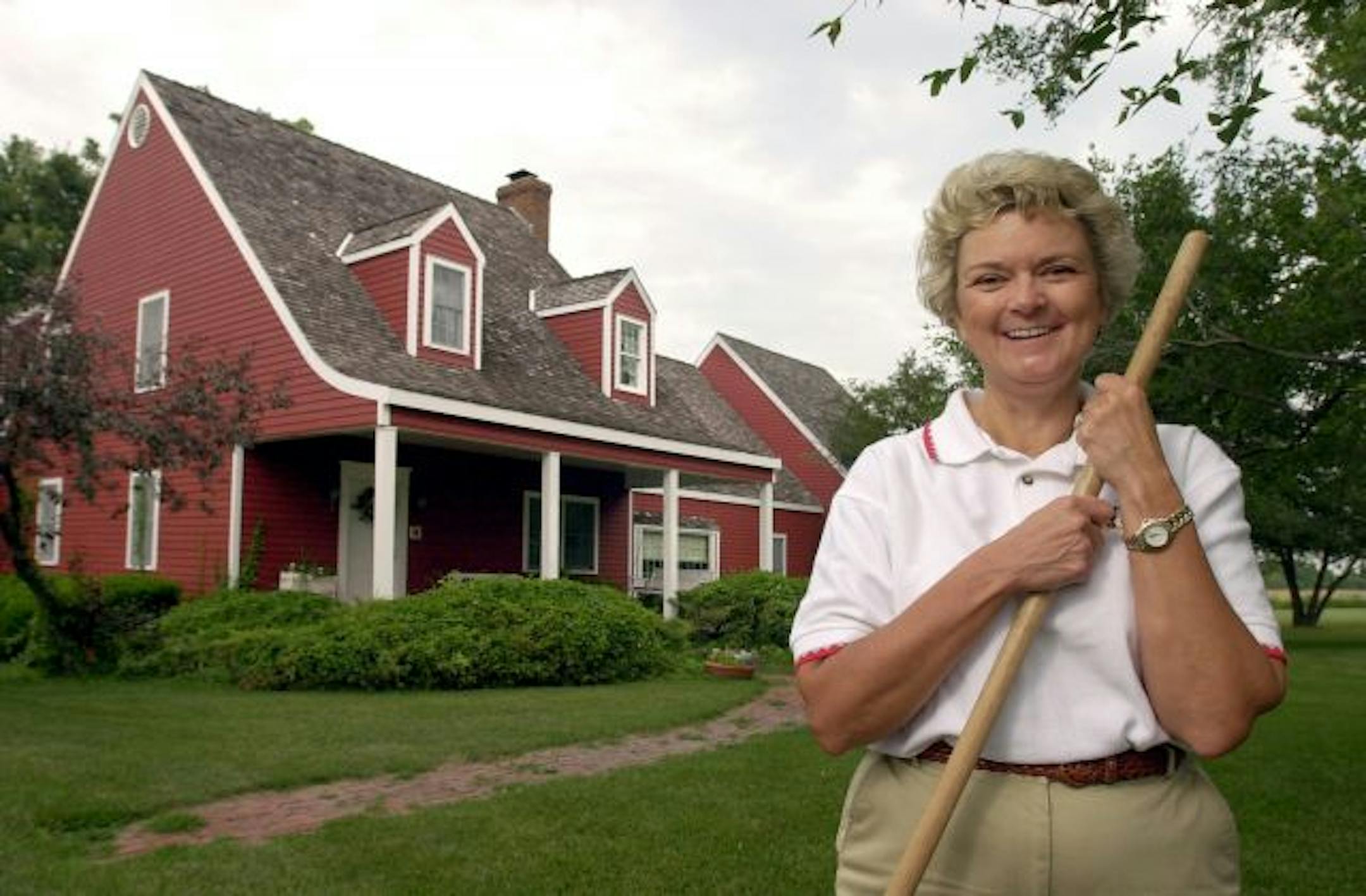 Kaye Malins, who runs the Walt Disney Hometown Museum, stands in front her house — the same one that Walt Disney lived in with his family when they resided in Marceline.