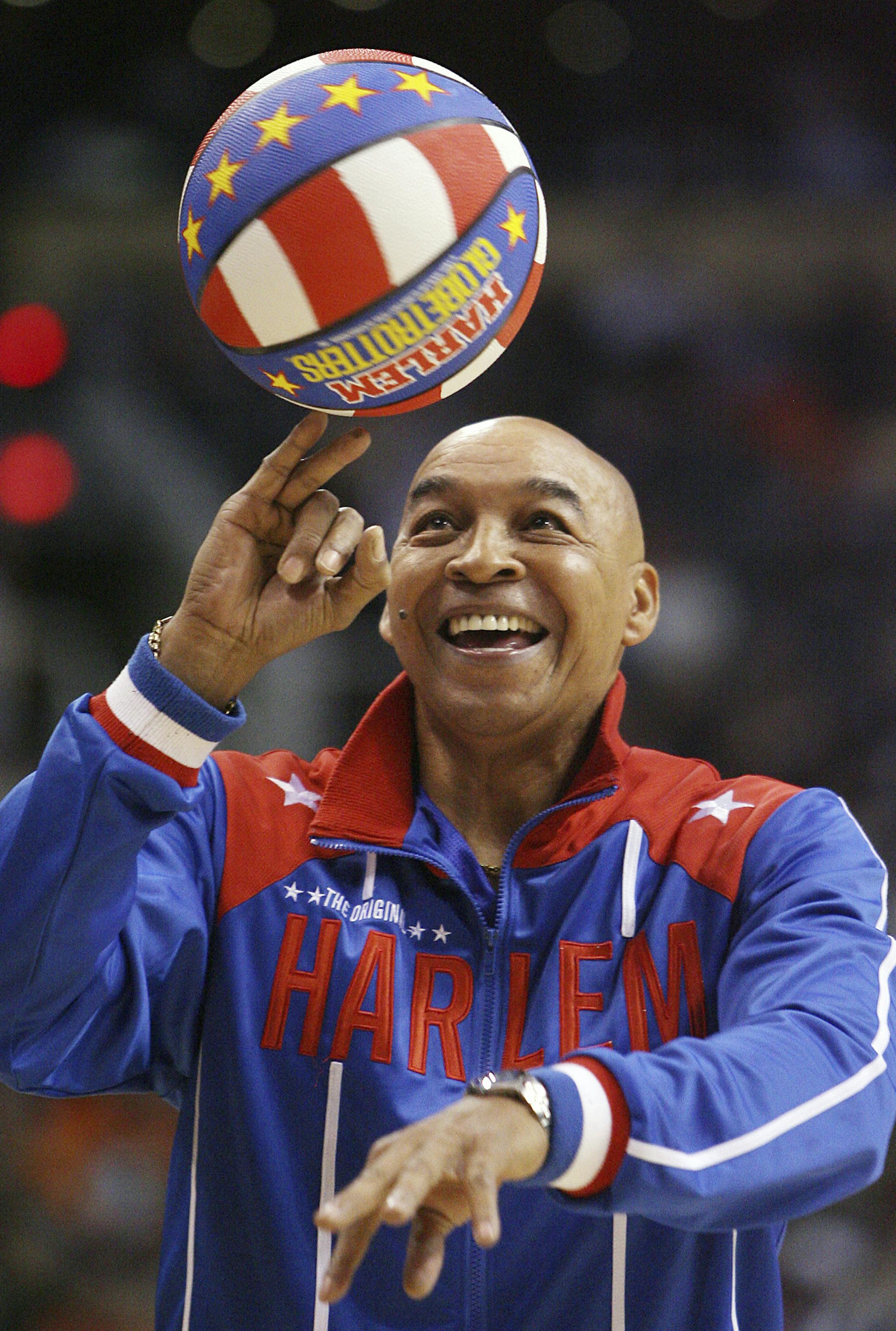 The Harlem Globetrotters' Fred "Curly" Neal performs during a timeout in the second quarter in an NBA basketball game between the Indiana Pacers and the Phoenix Suns in Phoenix. Neal, the dribbling wizard who entertained millions with the Harlem Globetrotters for parts of three decades, has died the Globetrotters announced Thursday, March 26, 2020. He was 77. Neal played for the Globetrotters from 1963-85, appearing in more than 6,000 games in 97 countries for the exhibition team known for its c