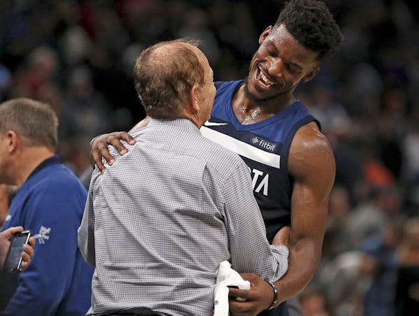 Minnesota Timberwolves forward Jimmy Butler (23) talked with Minnesota Timberwolves team owner Glen Taylor on the court following the win.