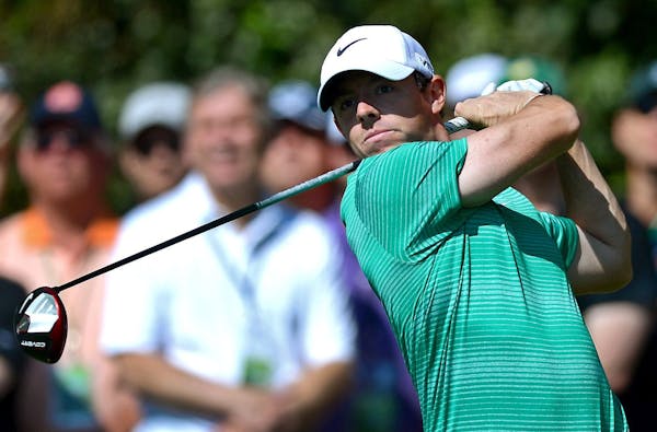 Rory McIlroy watches his drive from the 14th tee during a practice round for the Masters Tournament at Augusta National Golf Club in Augusta, Ga., on 