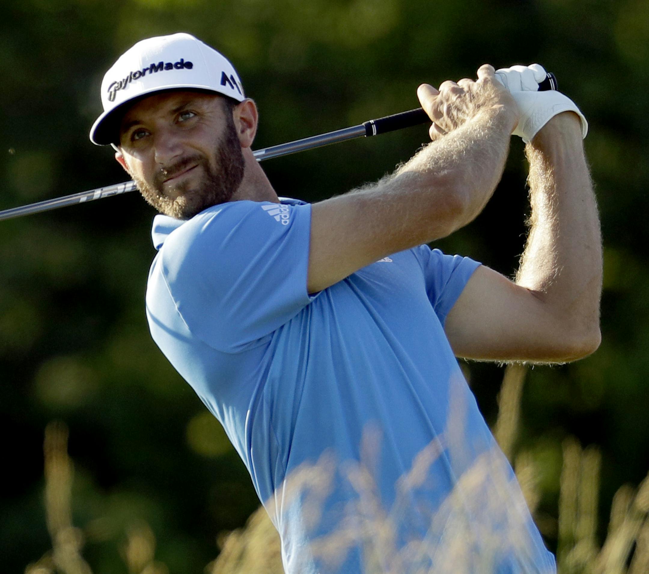 Dustin Johnson watches his tee shot on the fourth hole during the rain delayed second round of the U.S. Open golf championship at Oakmont Country Club on Friday, June 17, 2016, in Oakmont, Pa. (AP Photo/Charlie Riedel)