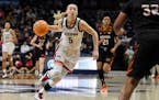 Connecticut’s Paige Bueckers drives to the basket during the first half of a first-round women’s college basketball game against Mercer in the NCA
