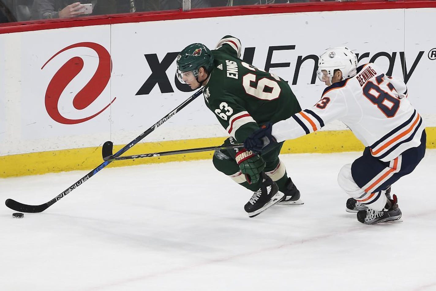 Minnesota Wild's Tyler Ennis (63) controls the puck against Edmonton Oilers' Matt Benning (83) in the first period of an NHL hockey game Saturday, Dec. 16, 2017, in St. Paul, Minn.