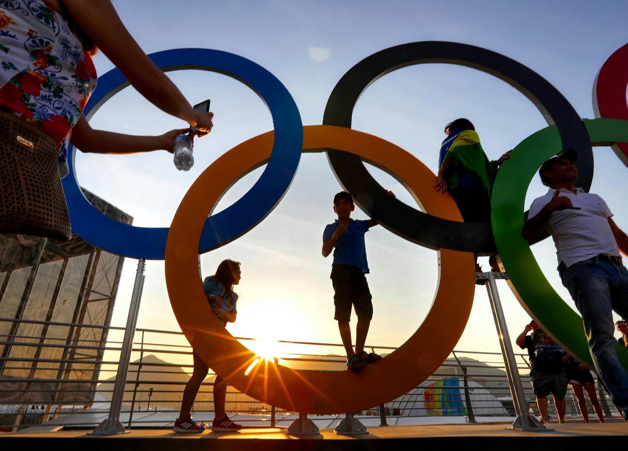 Olympic Park was hopping with Olympic fans on the first day of competition. Here, fans waited in a long line to get their pictures taken with the Olympic rings as the sun set in Rio. ] 2016 Summer Olympic Games - Rio Brazil brian.peterson@startribune.com Rio de Janeiro, Brazil - 08/06/2016