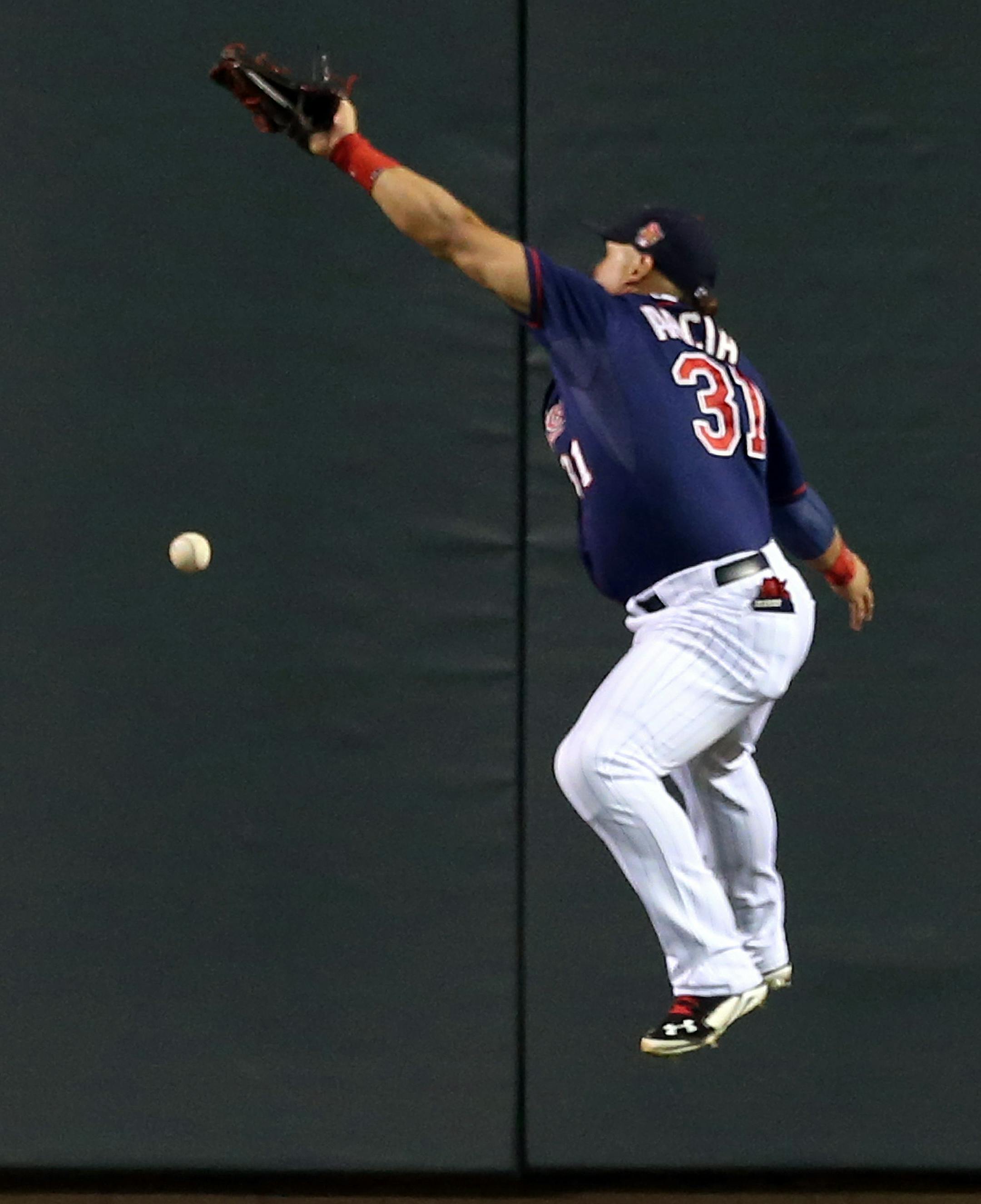 Minnesota Twins right fielder Oswaldo Arcia makes a vain attempt to catch a ball hit for a double by Los Angeles Angels' Kole Calhoun in the fourth inning of a baseball game, Friday, Sept. 5, 2014, in Minneapolis. (AP Photo/Jim Mone)