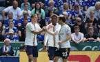 Everton’s Vitaliy Mykolenko, left, celebrates with his teammates after scoring against Leicester City in a Premier League match Sunday.