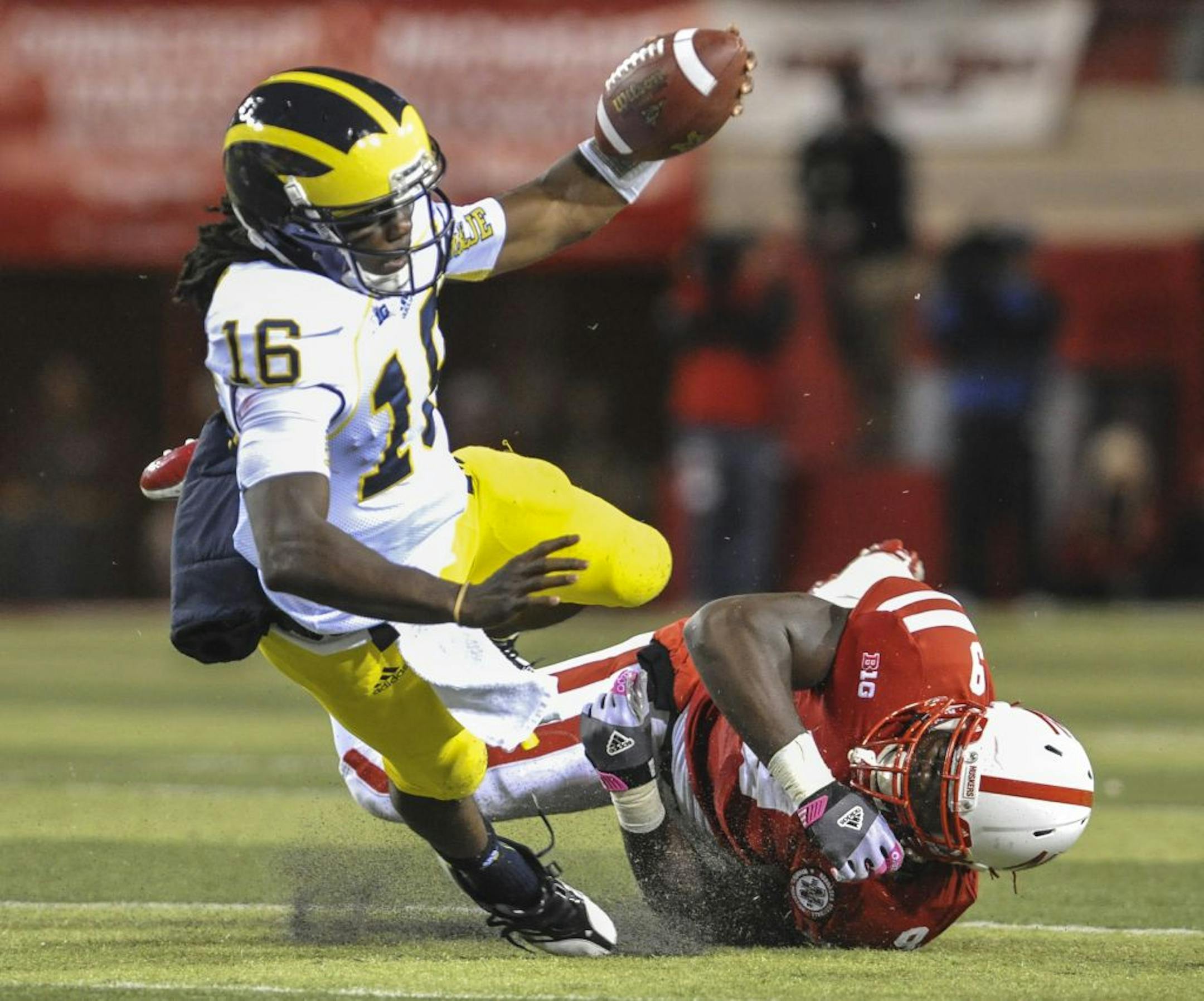 Michigan quarterback Denard Robinson was tripped up by Nebraska's Jason Ankrah during the first half Saturday.