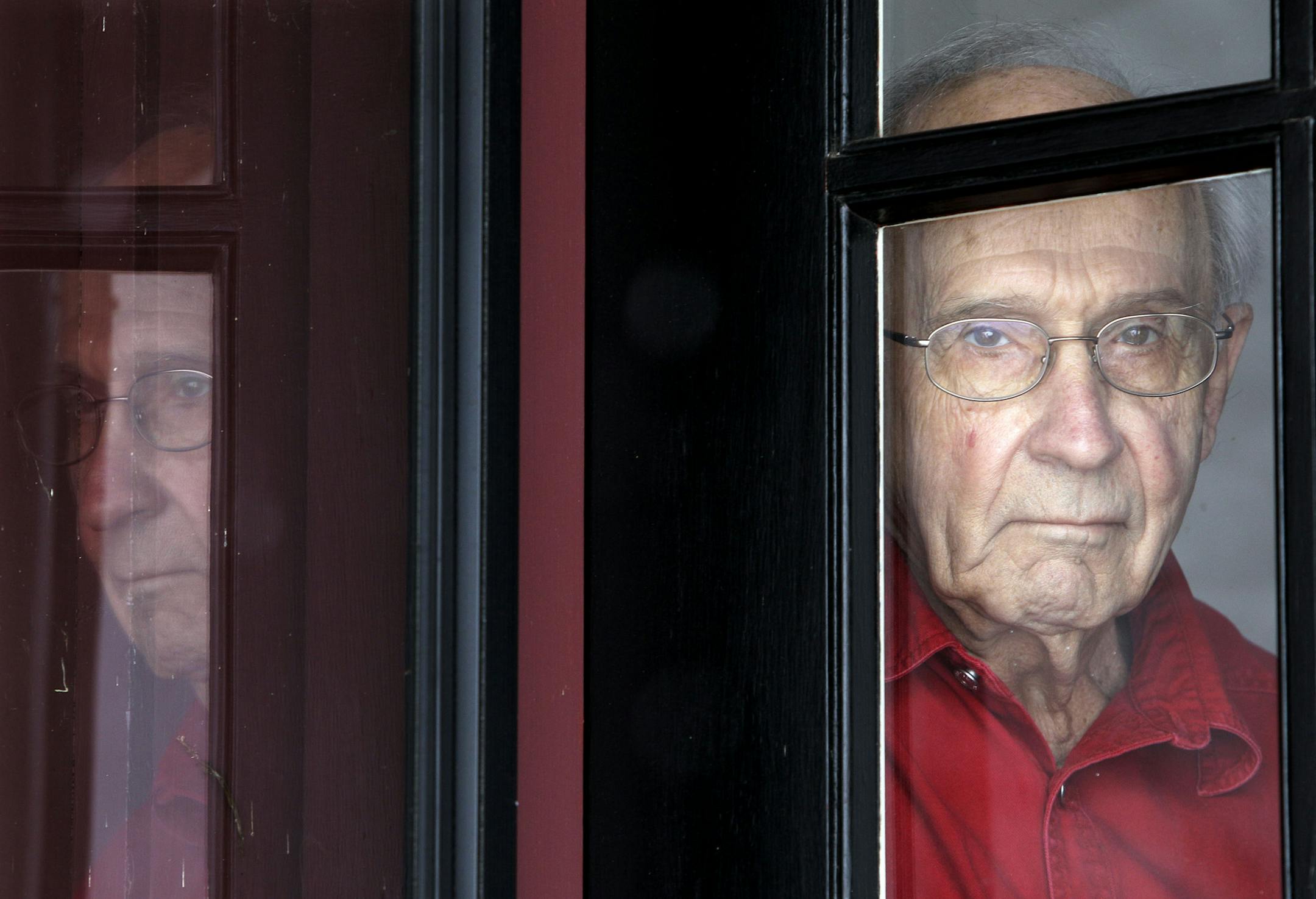 In this photo taken on Dec. 4, 2010, 85-year-old Eb Fuhr looks out a window of his home in Palatine, Ill. Fuhr‚Äôs German-born parents emigrated to the U.S. when he was 3 and he grew up in Cincinnati where his father was a baker. Eight months after his parents and U.S.-born brother were seized in 1942, Fuhr was taken away by FBI agents who showed up at his high school in Cincinnati. ‚ÄúIt was kind of a reunion,‚Äù he said of joining his parents