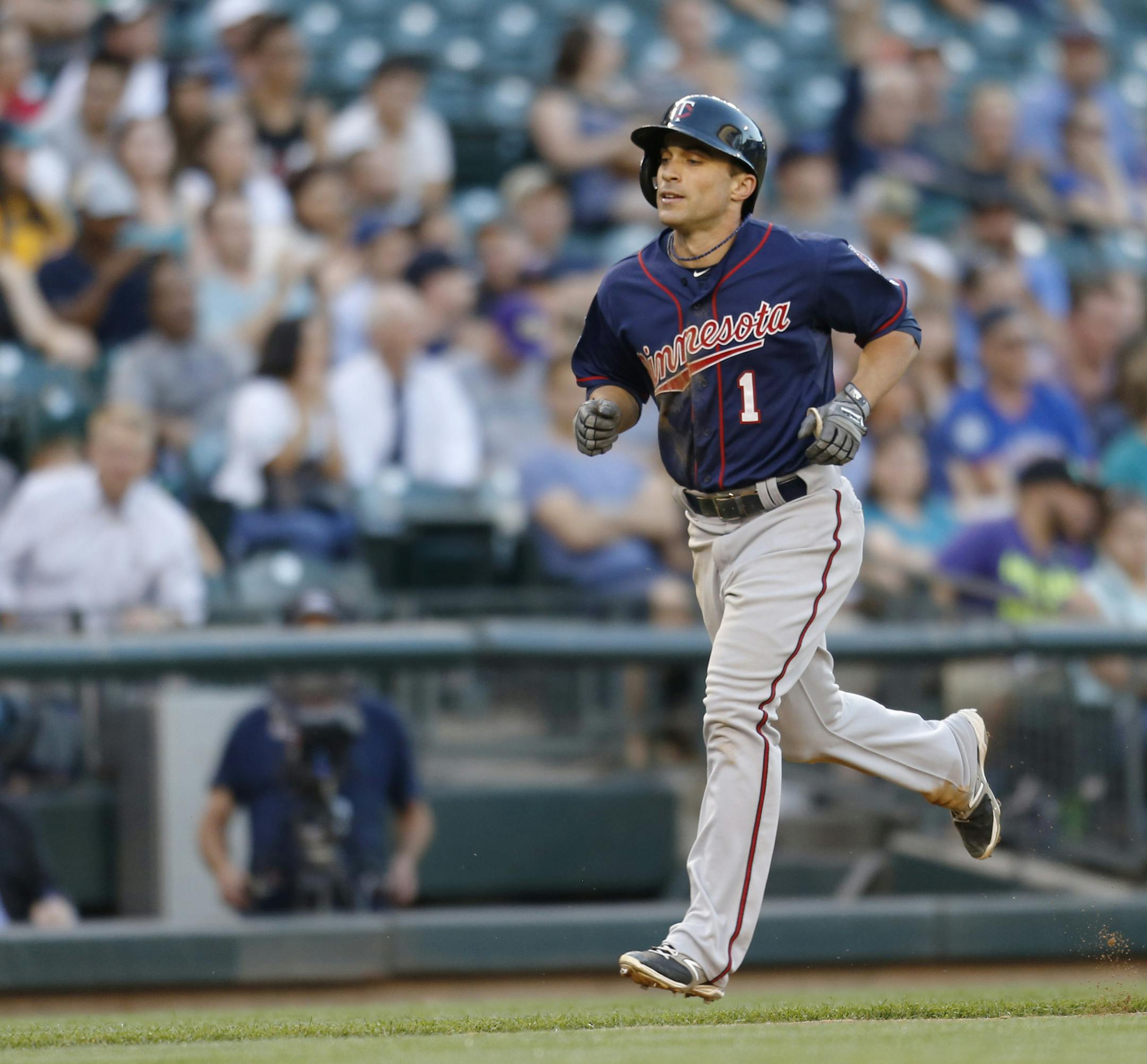 Minnesota Twins' Sam Flud rounds the bases after hitting a solo home run on a pitch from Seattle Mariners' Chris Young during the fifth inning of a baseball game on Tuesday, July 8, 2014 in Seattle. (AP Photo/John Froschauer)
