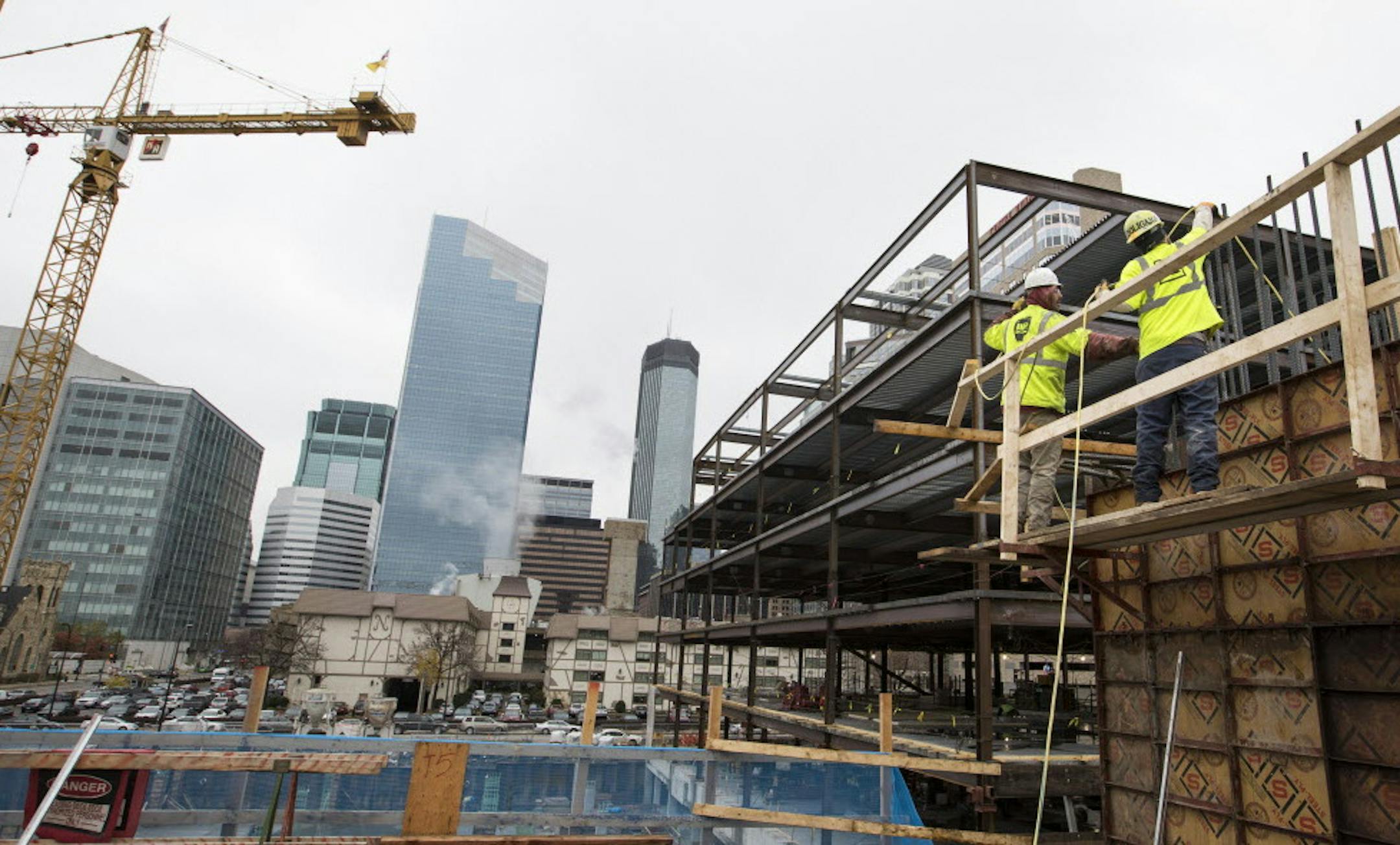 Construction workers work on the elevator shaft walls of a new 17-story residential tower located at Portland Ave. and 9th Street in downtown Minneapolis. ] (Leila Navidi/Star Tribune) leila.navidi@startribune.com BACKGROUND INFORMATION: Construction on a new 17-story residential tower located at Portland Ave. and 9th Street in downtown Minneapolis on Wednesday, October 26, 2016. The 306-unit apartment residence has been named “H.Q.” Owned by Kraus-Anderson, H.Q. is part of the new
