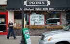 Jennifer King, co-owner of Prima in Minneapolis, delivered takeout orders to waiting customers in May.