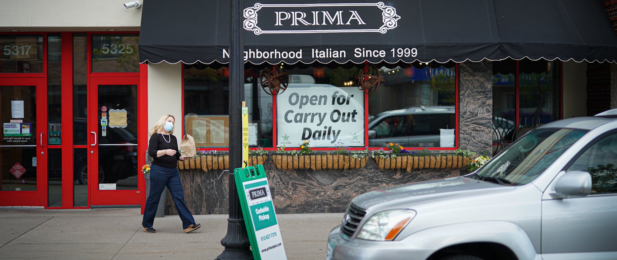 Jennifer King, co-owner of Prima in Minneapolis, delivered takeout orders to waiting customers in May.