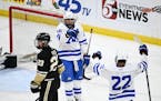 Minnetonka forward Gavin Garry (15) and forward Javon Moore (22) react after Garry scored a goal against Andover with an assist from Moore during the 