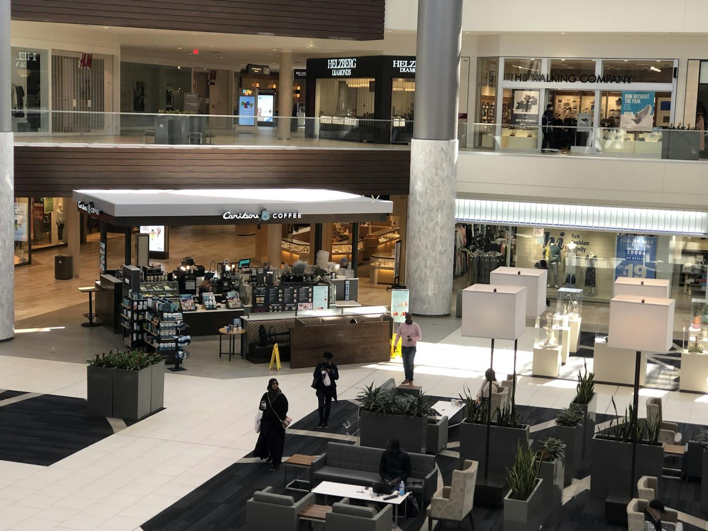 More people were at the Caribou Coffee in the atrium at Ridgedale Center Friday afternoon than in the stores around it. Ridgedale and a handful other shopping centers remain open even as crowds have fallen off and other malls closed due to coronavirus.