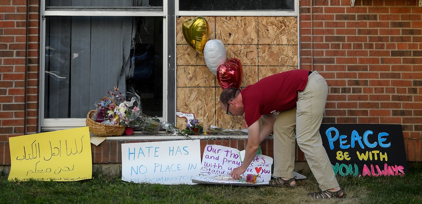 Ben Sunderlin placed a sign of support near the window that was damaged during Saturday morning's attack at the Dar Al Farooq Islamic Center in Bloomington. ] AARON LAVINSKY &#xef; aaron.lavinsky@startribune.com More than a thousand people attended a community-wide show of support for Dar Al Farooq Islamic center in Bloomington on Tuesday, Aug. 8, 2017 following an attack on the center early Saturday morning. .