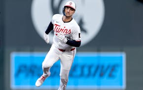 Twins right fielder Matt Wallner rounds the bases after hitting a triple on April 14. He injured his left hamstring running the bases the next night a