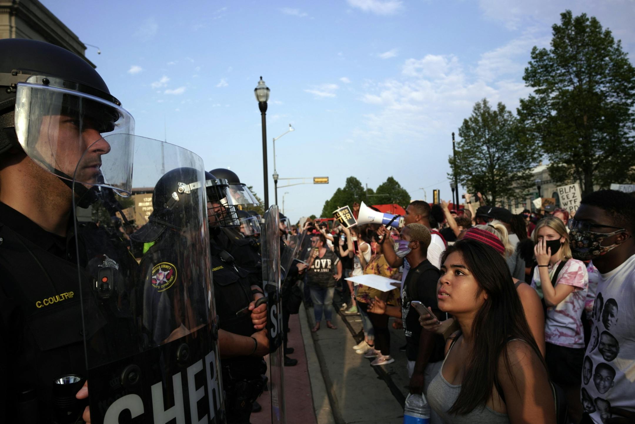 Law enforcement officials line up against protesters in Kenosha, Wis., on Monday evening, Aug. 24, 2020, during a demonstration against the police shooting of Jacob Blake. Peaceful marches gave way to fires, destruction and looting in Kenosha as a strip of businesses in a central residential neighborhood was consumed in flames early Tuesday. (Carlos Javier Ortiz/The New York Times)