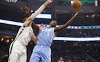 The Bucks' Brook Lopez (11) and the Timberwolves' Gorgui Dieng reached for a rebound during the first half Wednesday.