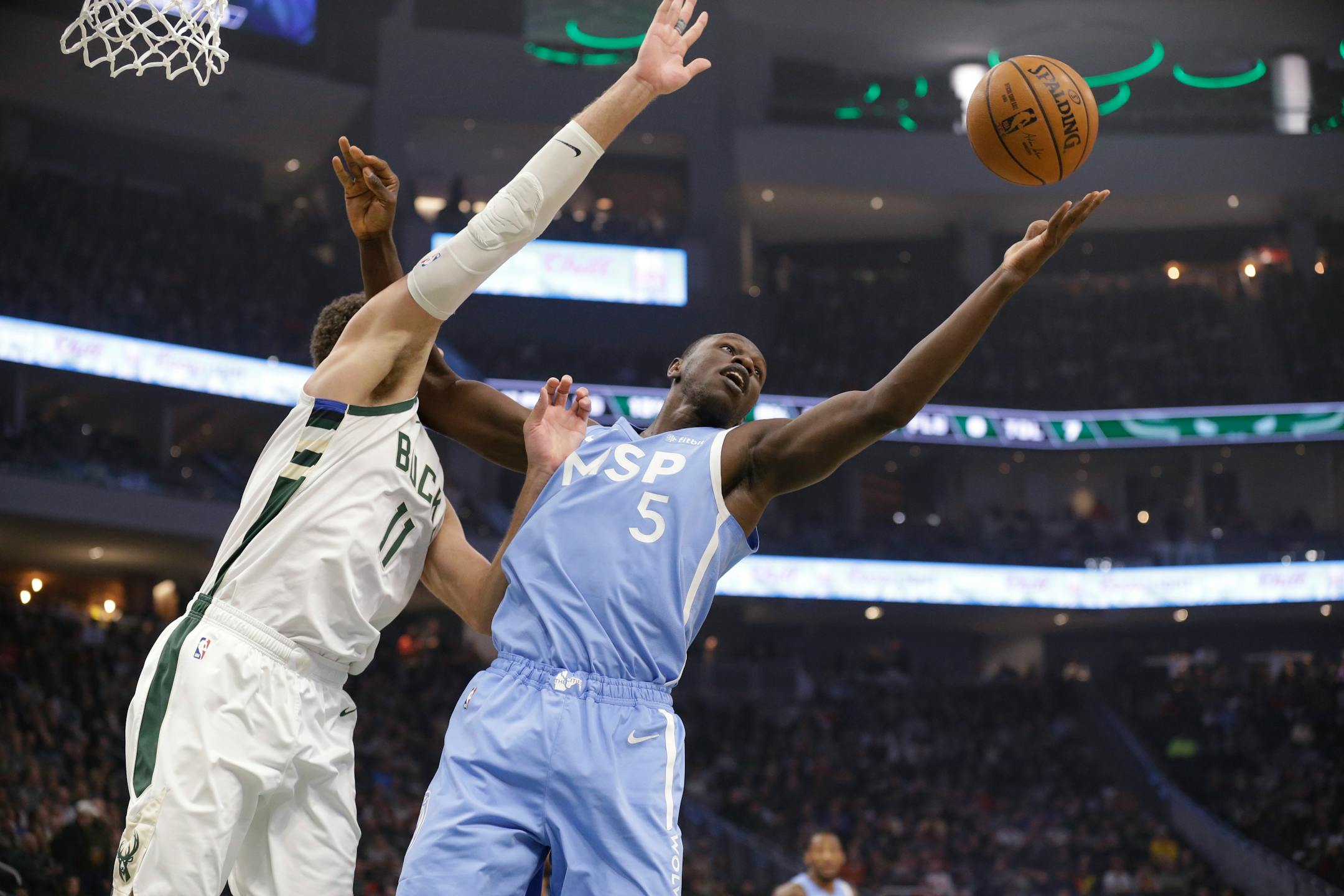 The Bucks' Brook Lopez (11) and the Timberwolves' Gorgui Dieng reached for a rebound during the first half Wednesday.