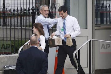 Minnesota's Denis McDonough greets returning federal workers at White House gates