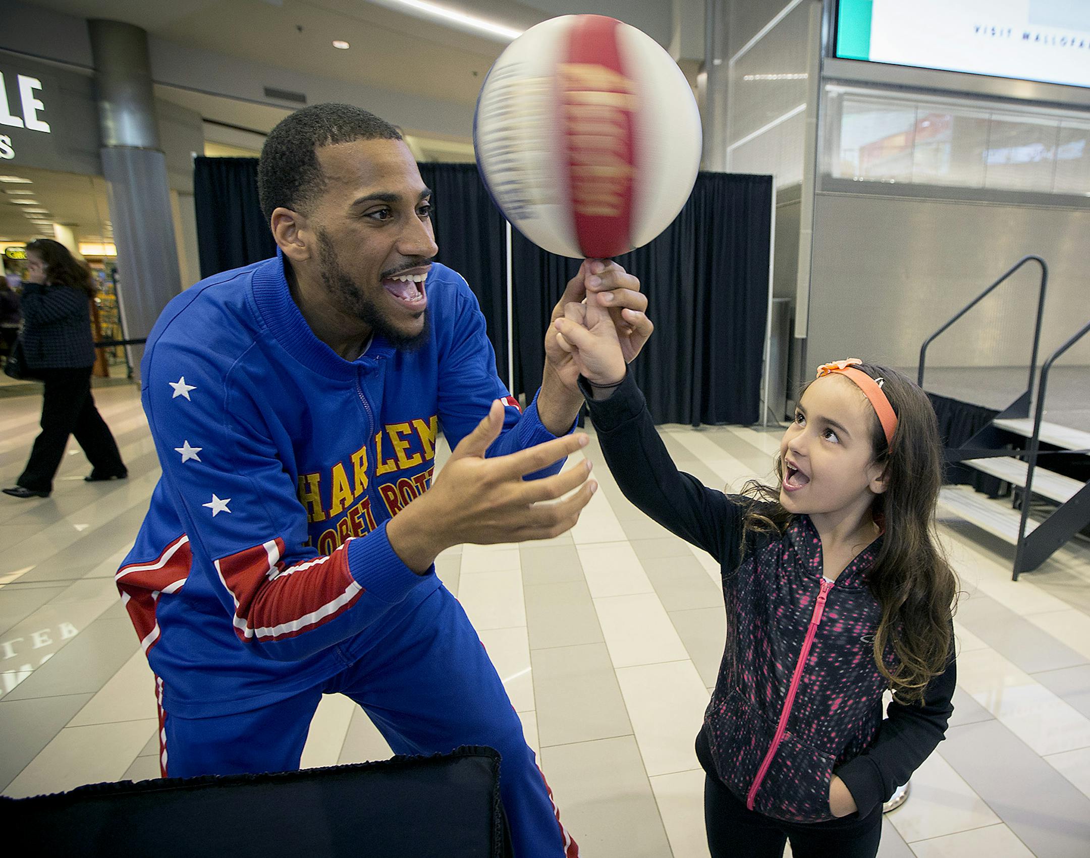 Zeus McClurkin, a forward with the world-famous Harlem Globetrotters, showed Diana Anderson, 8, how to spin a basketball on her finger during an appearance at the Mall of America, Tuesday, April 11, 20017 in Bloomington, MN. Zeus was this weekís special Toddler Tuesday guest at Mall of America. Zeus is also a Guinness World RecordsÆ record-holder. On Nov. 17, 2016, he set the mark for the most basketball slam dunks in one minute with 16. Zeus also set a new record for the most bounced