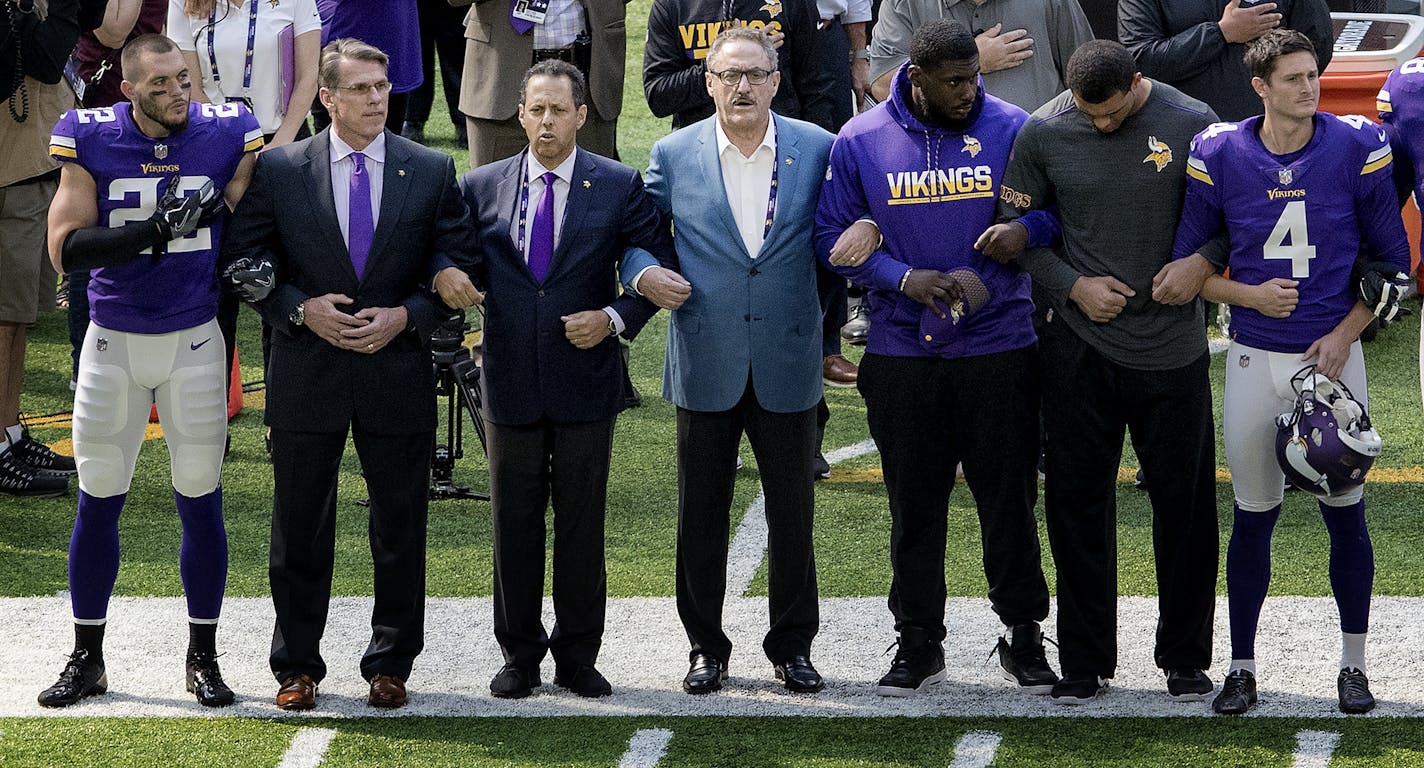 Vikings General Manager Rick Spielman and owners Mark Wilf and Zygi Wilf stood with players including Harrison Smith (22) during the national anthem before the start of a game vs. the Tampa Bay Buccaneers at U.S. Bank Stadium.