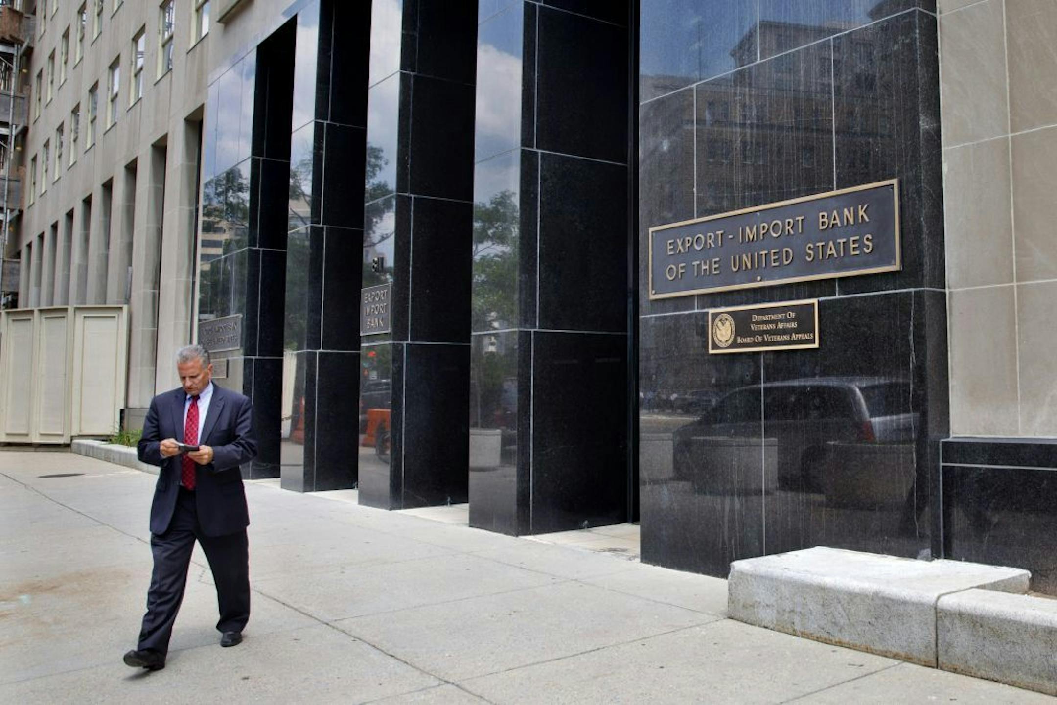 FILE - In this July 28, 2015, file photo, a man walks out of the Export-Import Bank of the United States in Washington. A strong coalition of establishment-backed Republicans and House Democrats voted overwhelmingly Oct. 27 to revive the Export-Import Bank, dealing a defeat to tea party conservatives and Speaker-to-be Paul Ryan.