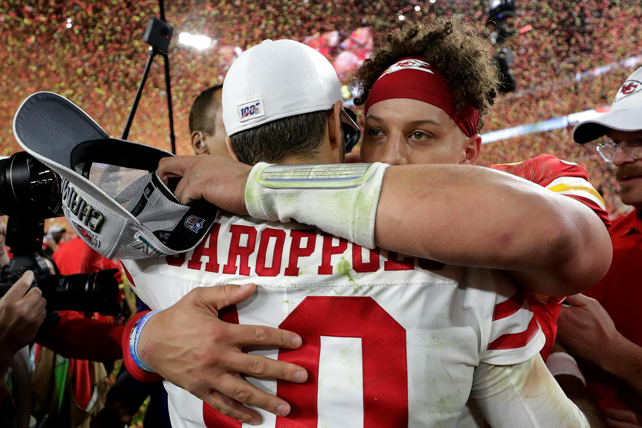 Kansas City Chiefs' quarterback Patrick Mahomes, rear, embraces San Francisco 49ers' quarterback Jimmy Garoppolo after winning the NFL Super Bowl 54 football game Sunday, Feb. 2, 2020, in Miami Gardens, Fla.