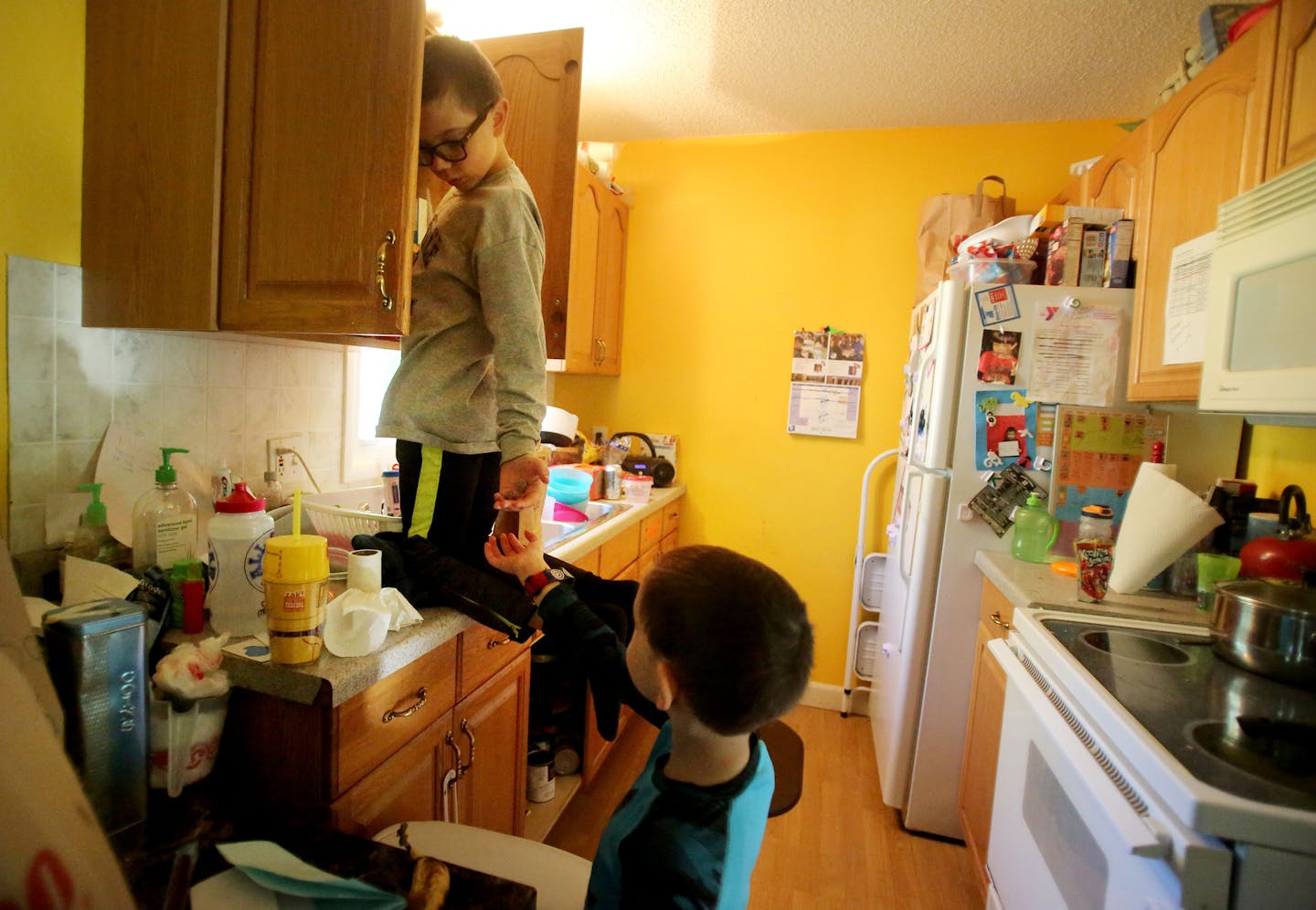 At the request of his mom, Mark climbs the counter in the kitchen after darting from the couch to retrieve vitamins for his brothers, stashed up high and out of their reach, before distributing them to two of his brothers Wednesday, May 18, 2016, before the start of the school day.](DAVID JOLES/STARTRIBUNE)djoles@startribune Each day, an estimated 30,000 to 40,000 children across Minnesota provide care to someone in their family who is physically or mentally disabled and is too debilitated to ca