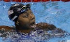 United States' Simone Manuel celebrates winning the gold medal and setting a new olympic record in the women's 100-meter freestyle during the swimming