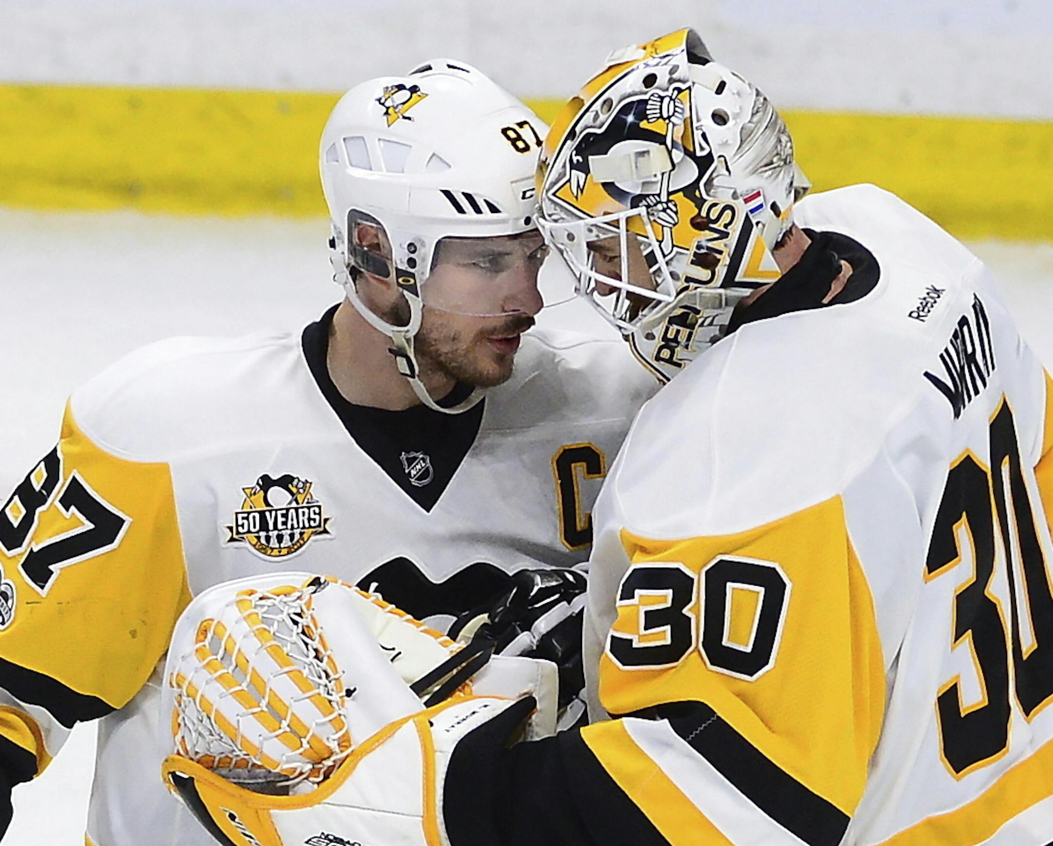 Pittsburgh Penguins center Sidney Crosby (87) celebrates with goalie Matt Murray (30) after the Penguins' 3-2 win over the Ottawa Senators during Game 4 of the NHL hockey Stanley Cup Eastern Conference finals, Friday, May 19, 2017, in Ottawa, Ontario. (Sean Kilpatrick/The Canadian Press via AP)