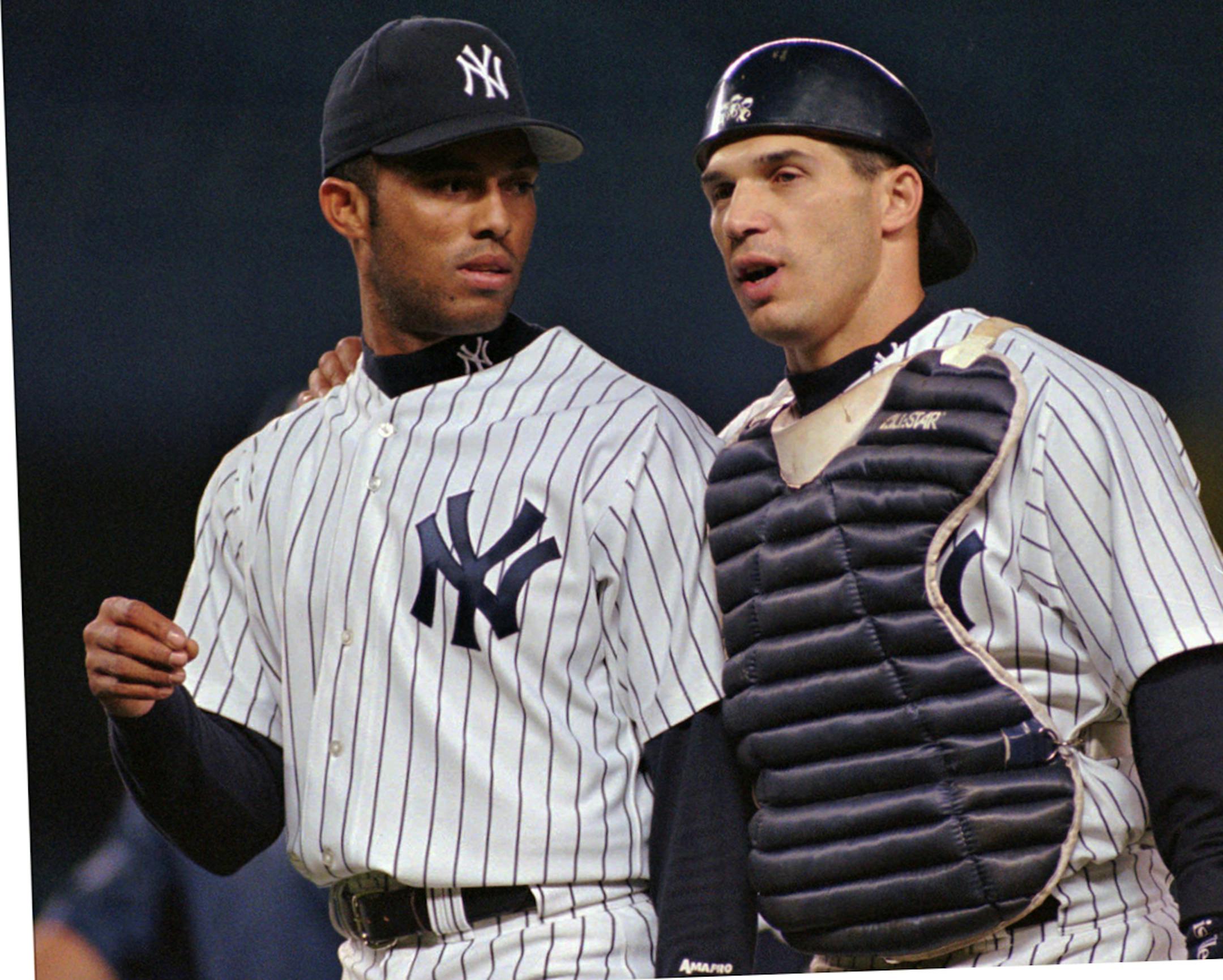 New York Yankees relief pitcher Mariano Rivera, left, talks with catcher Joe Girardi, right, after pitching his way out of a jam with the bases loaded in the ninth inning of their game against the Texas Rangers Thursday, May 8, 1997, at Yankee Stadium in New York. Rivera picked up his eleventh save of the season as the Yankees beat the Rangers 5-4. (AP Photo/John Dunn) ORG XMIT: NYY101