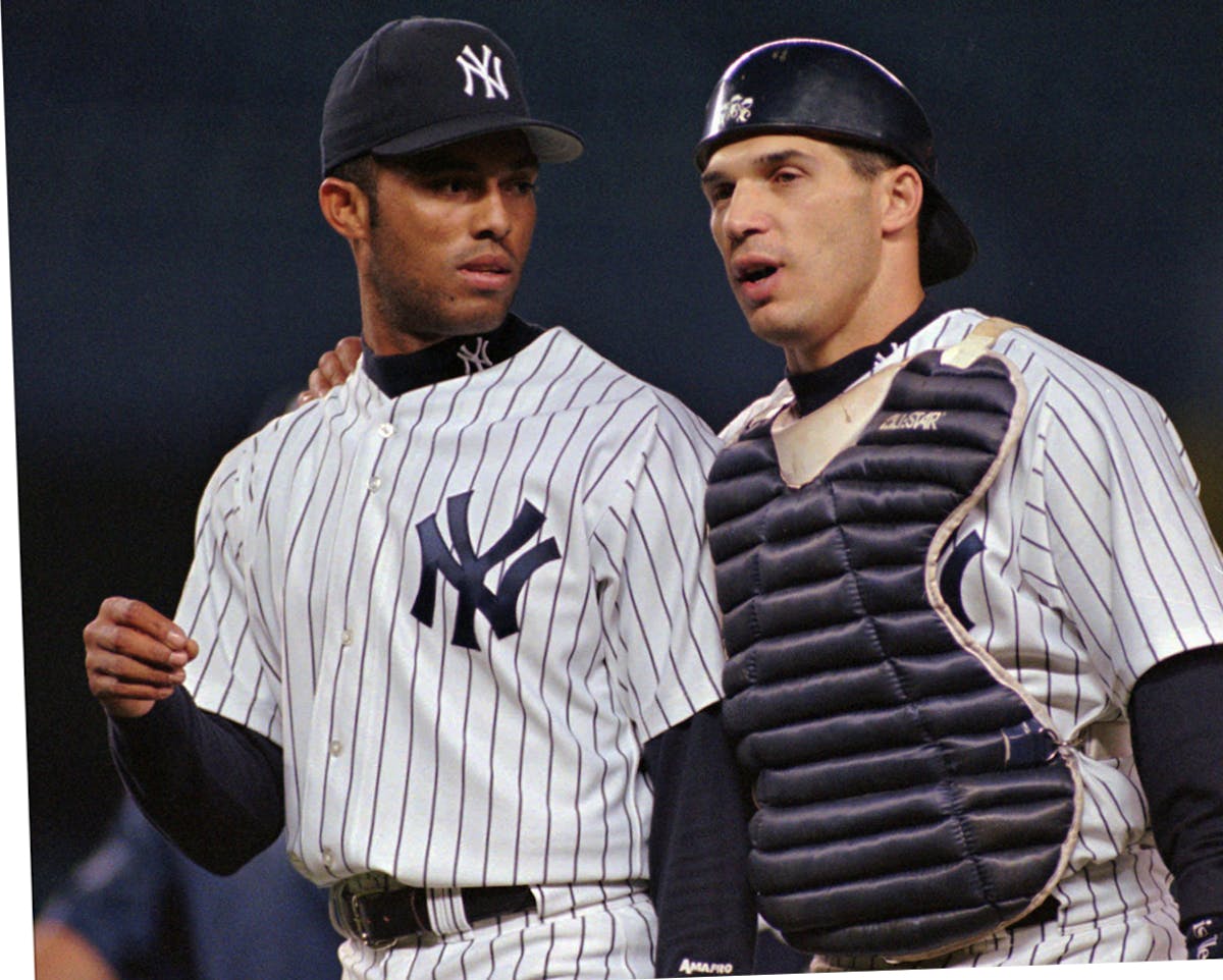 New York Yankees relief pitcher Mariano Rivera, left, talks with catcher Joe Girardi, right, after pitching his way out of a jam with the bases loaded