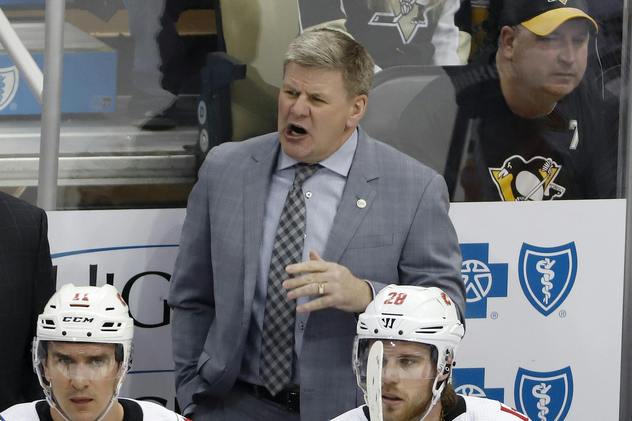 Calgary Flames head coach Bill Peters gives instructions during the first period of an NHL hockey game against the Pittsburgh Penguins in Pittsburgh, Saturday, Feb. 16, 2019. The Flames won 5-4. (AP Photo/Gene J. Puskar) ORG XMIT: PAGP120