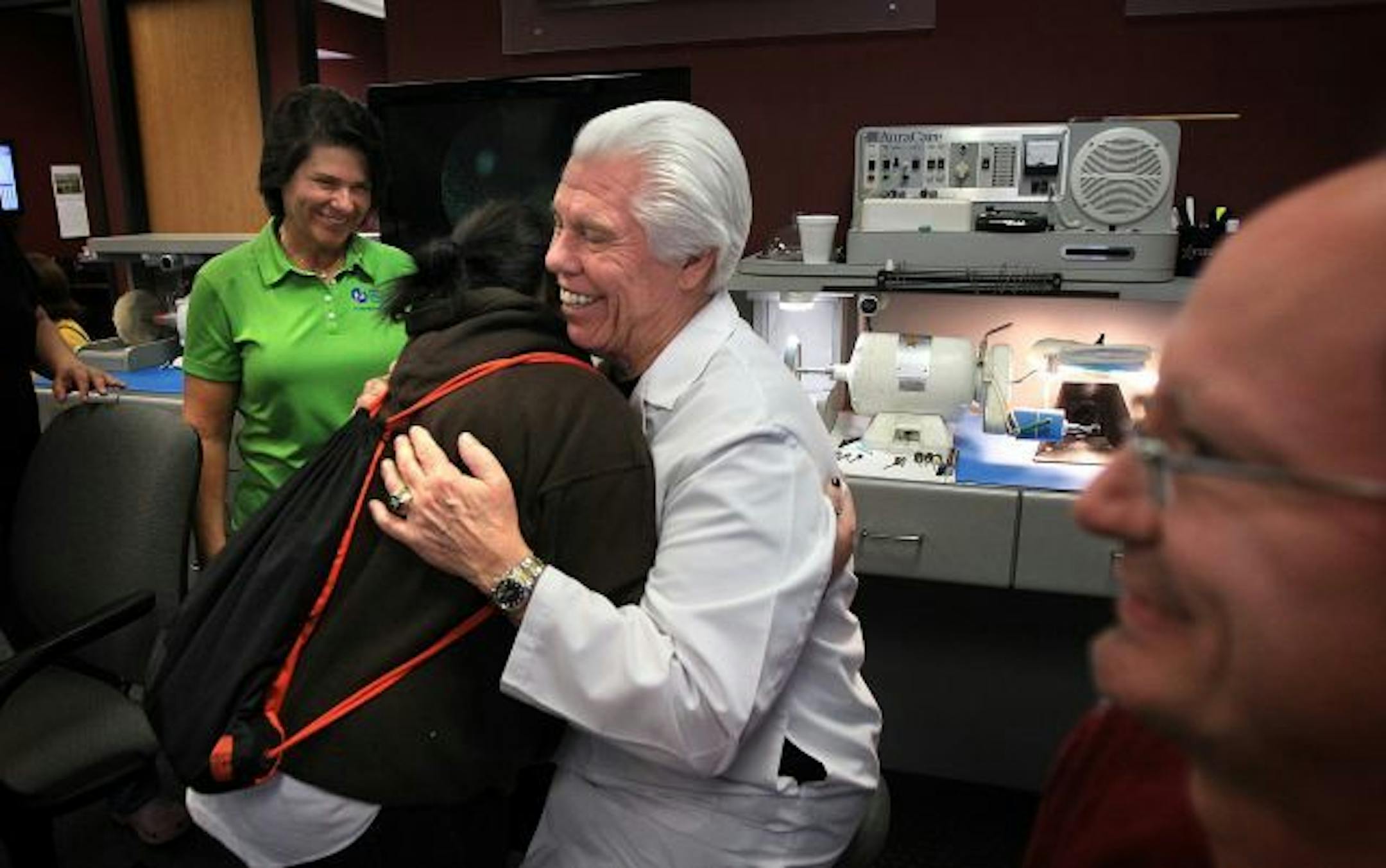 Jordan Renee Hill, 18, got a hug from Starkey Hearing Foundation founder Bill Austin as Austin's wife, Tani (left) looked on.