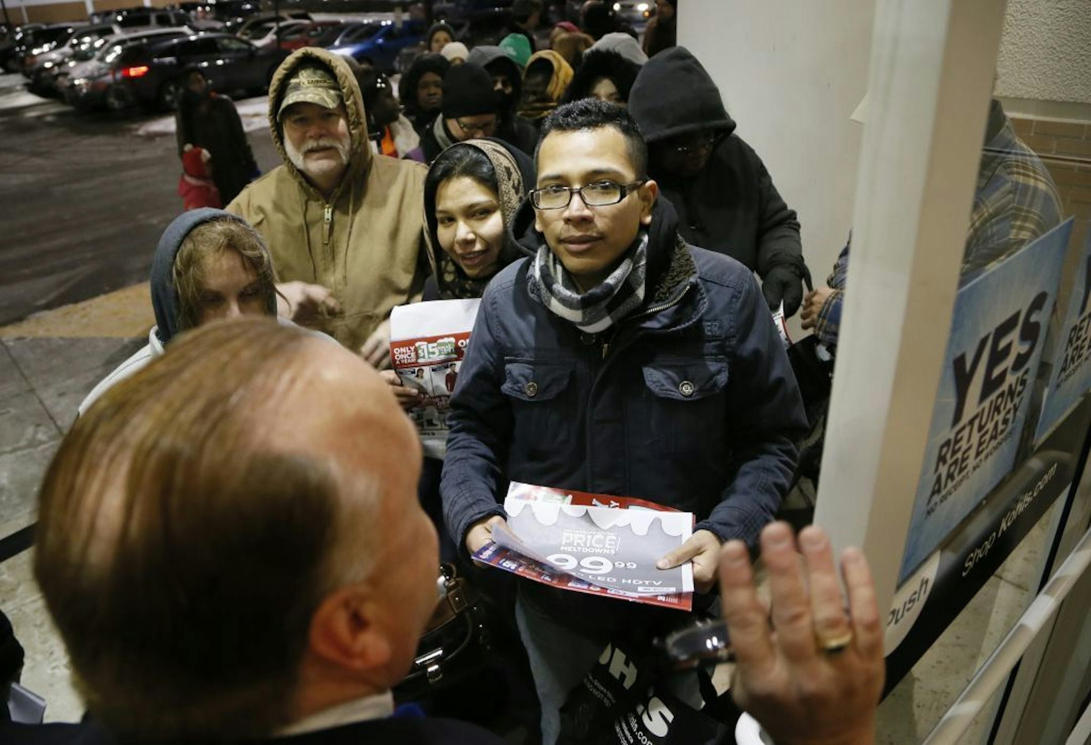 Scott Chesney, the manger at Kohls in Bloomington, gave instructions to shoppers before the store opened at 6 p.m. Thursday.