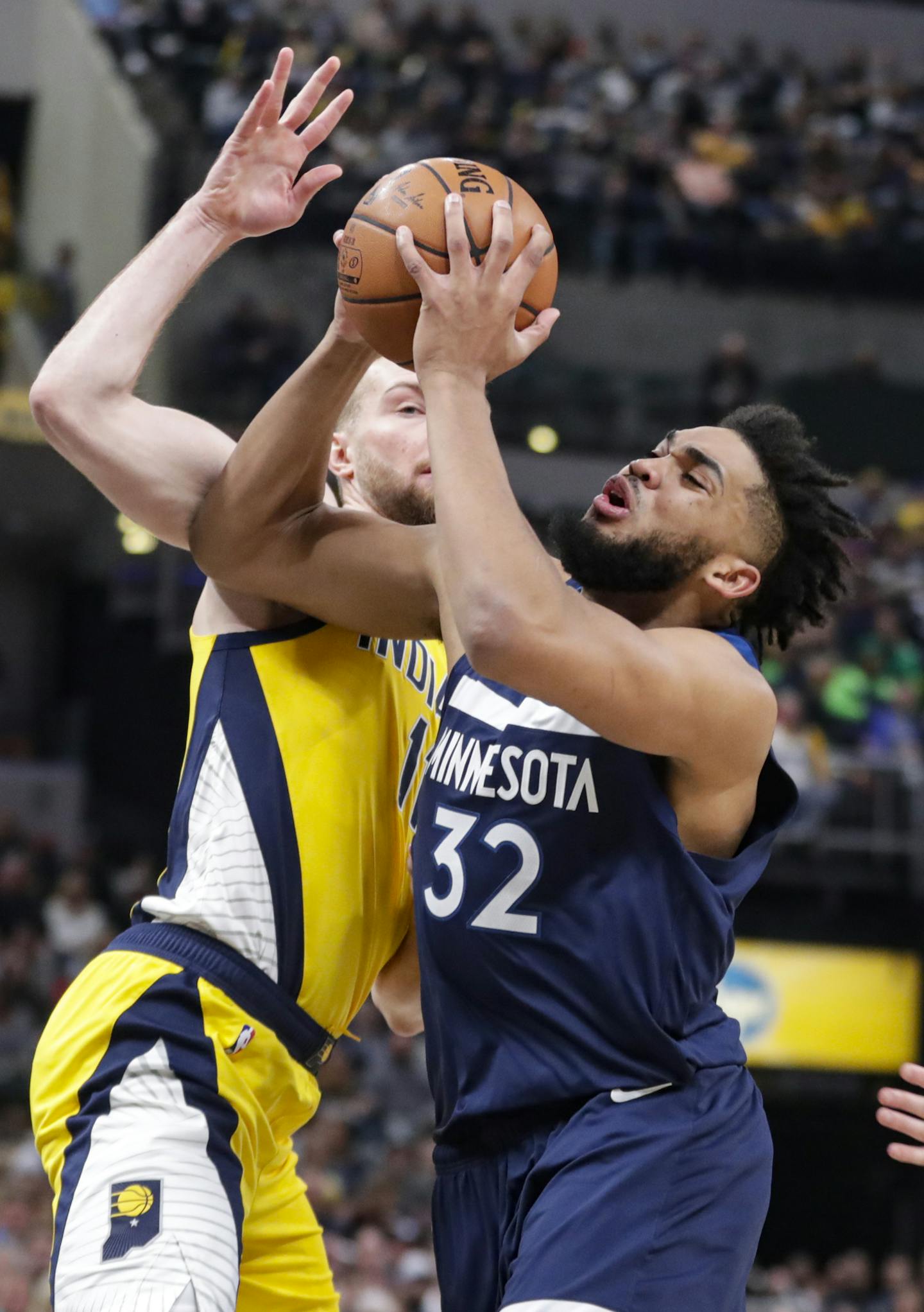 Minnesota Timberwolves center Karl-Anthony Towns (32) shoots in front of Indiana Pacers forward Domantas Sabonis (11) during the first half of an NBA basketball game in Indianapolis, Friday, Jan. 17, 2020. (AP Photo/Michael Conroy)