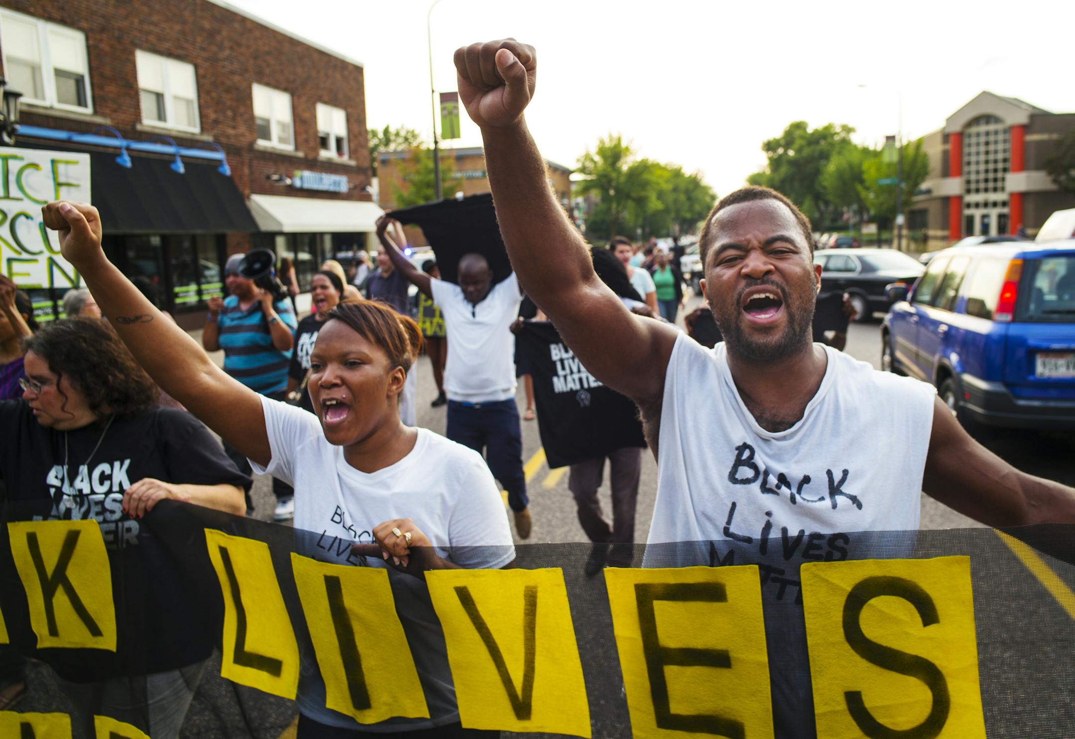 Protest leader, Rashad Turner, far right, led dozens of protesters in the neighborhood around Governor's Manson on Summit Ave. in St. Paul.Richard Tsong-Taatarii/rtsong-taatarii@startribune.com